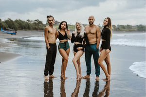 Group of men and women wearing yoga pants and yoga shorts and tops.